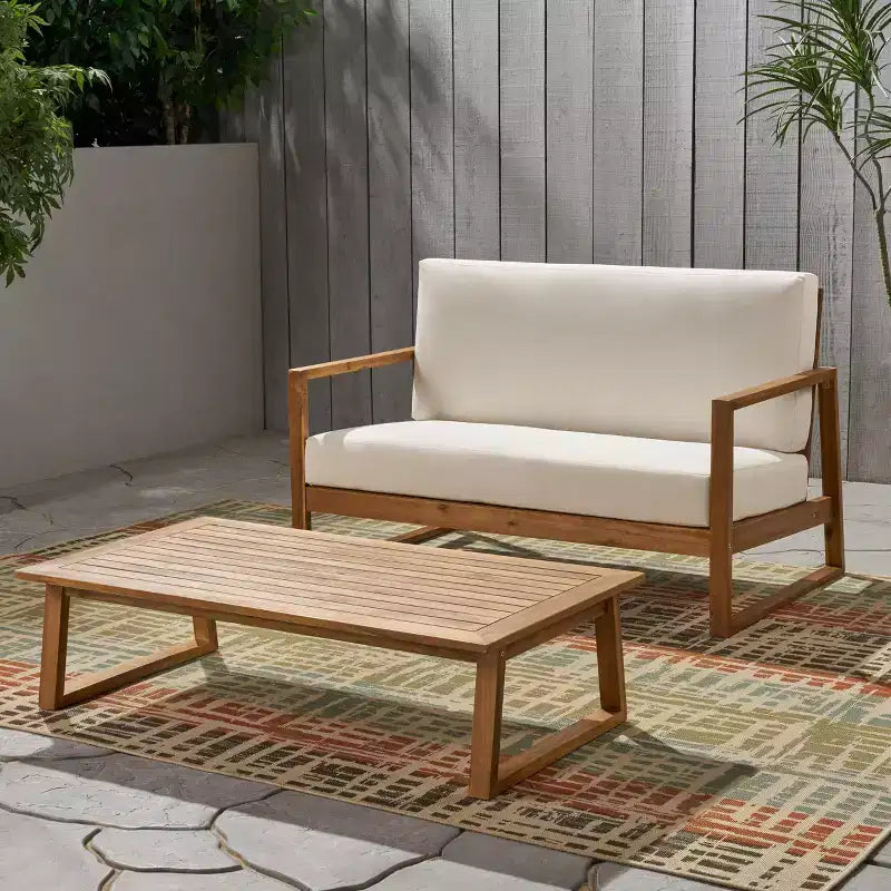 Conjunto Christopher Knight Home Hazel de sofá biplaza y mesa de centro de madera de acacia para exteriores, con cojines