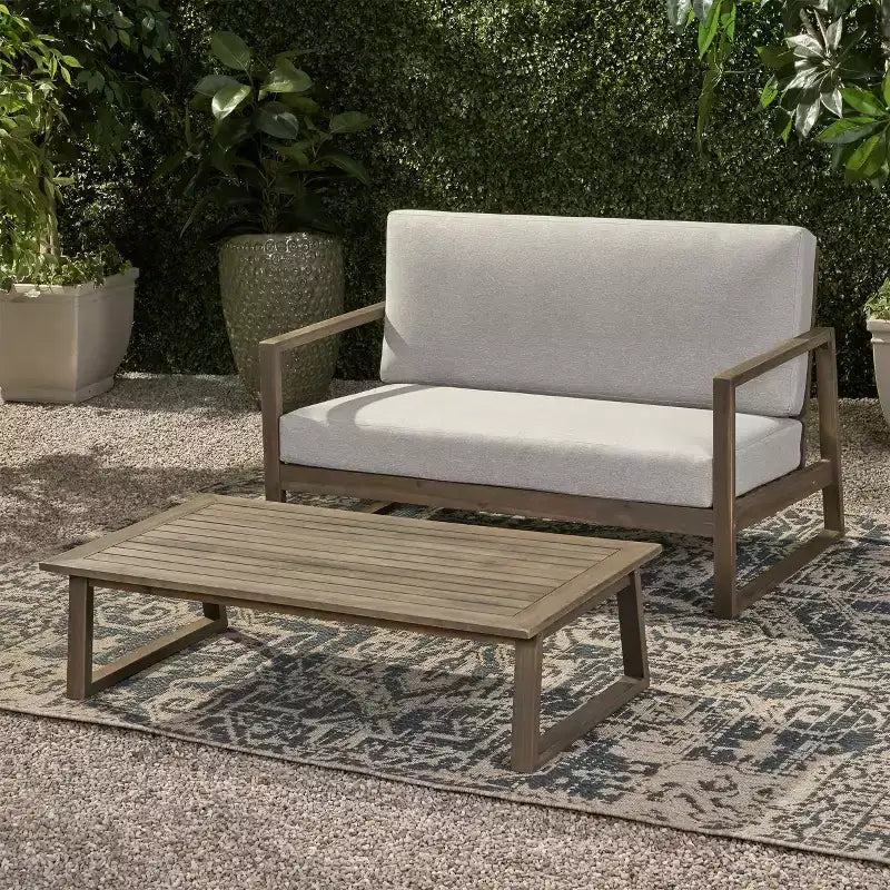 Conjunto Christopher Knight Home Hazel de sofá biplaza y mesa de centro de madera de acacia para exteriores, con cojines